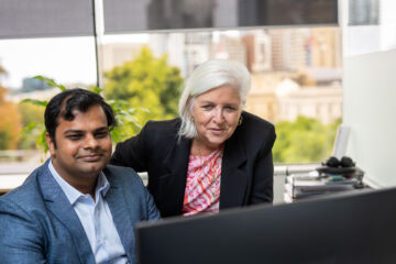 eWorks What makes us different 2 staff reviewing information on a computer