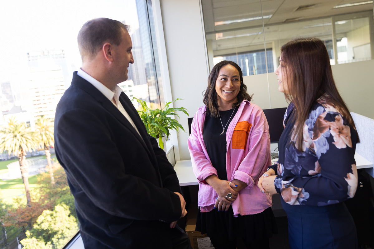 eWorks Content Development Process with 3 people standing by a large window