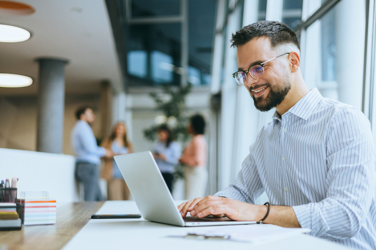 Young man using learning management system on laptop